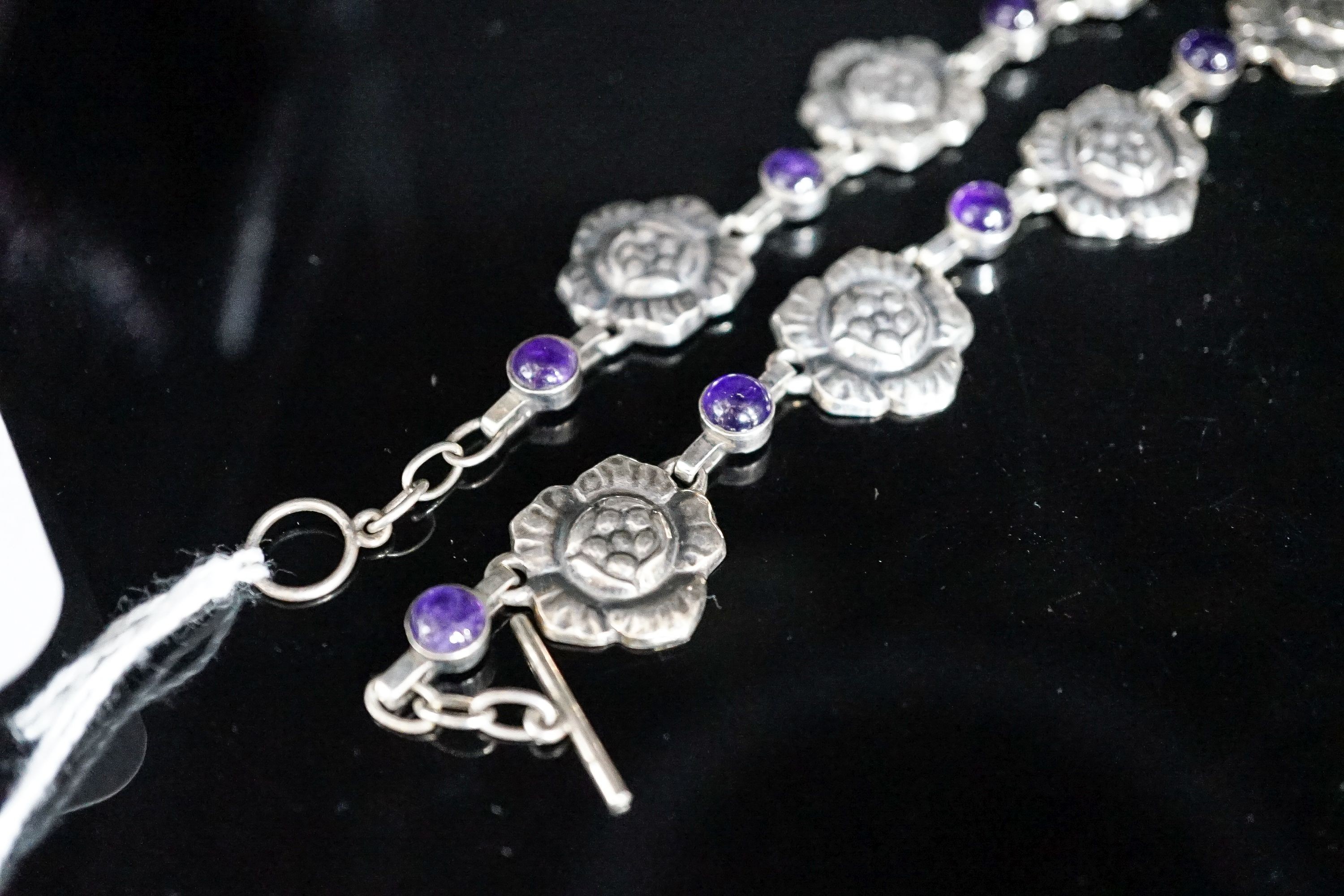 A Georg Jensen sterling flower head and cabochon amethyst link necklace, set with twelve stones. no. 5, approx. 42cm.